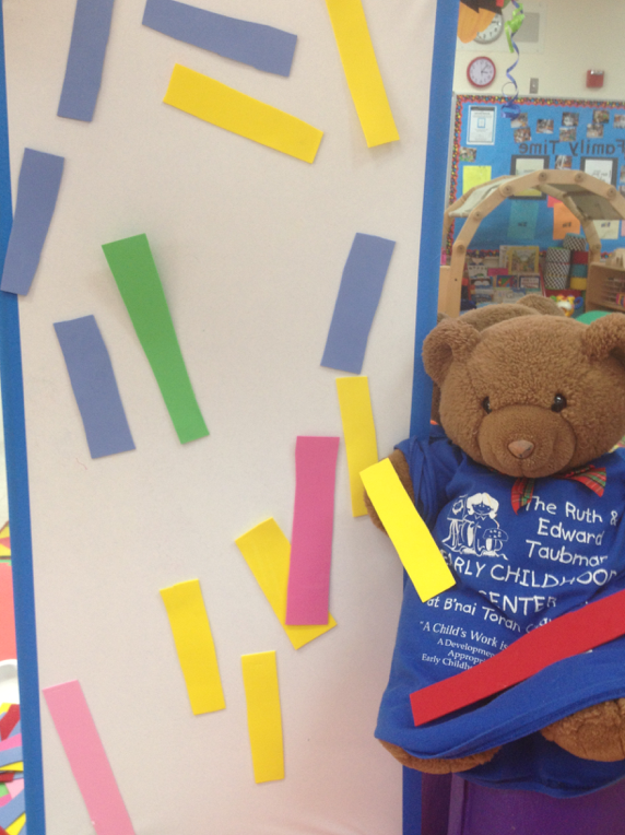 Sticky wall with colored rectangle paper shapes for fine motor skills
