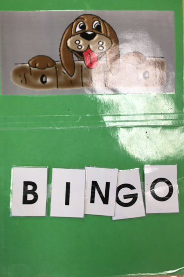 Cartoon dog and removeable BINGO letters on a large poster for use during circle time