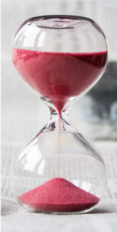 Plastic hourglass shaped timer with red sand 