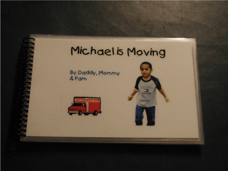 A laminated bound book titled Michael Is Moving by Daddy Mommy and Pam with images of Michael and a Uhaul Truck