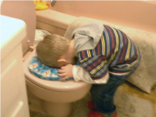 Young boy bent over looking in potty