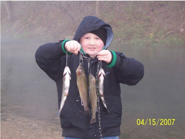 Boy holding a stringer of fish