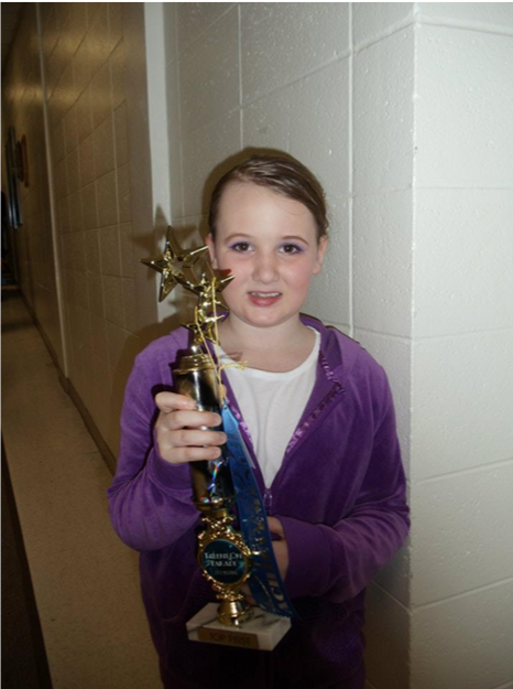 Girl holding trophy