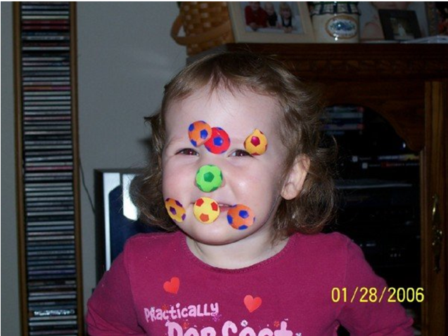 Young girl with stickers on her face