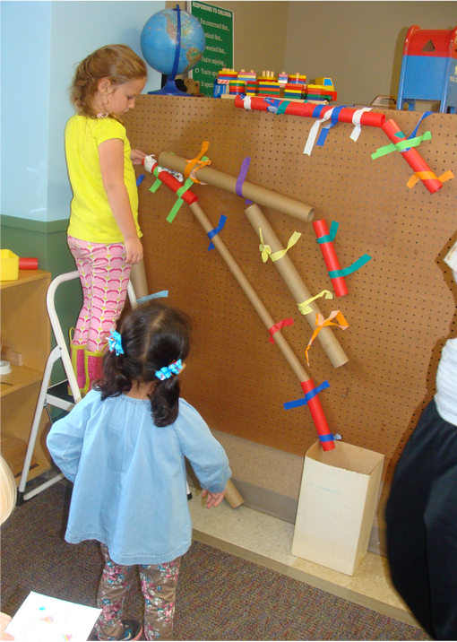 Children creating a ball drop.